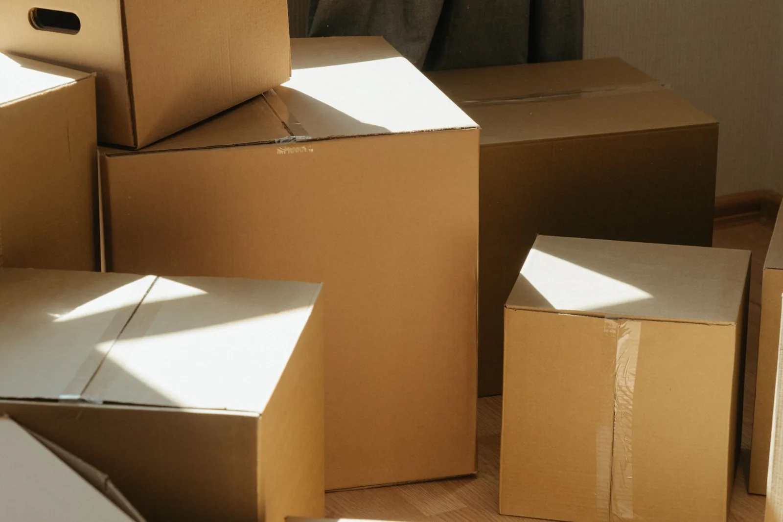 Cardboard boxes in a bright sunlit room during a move