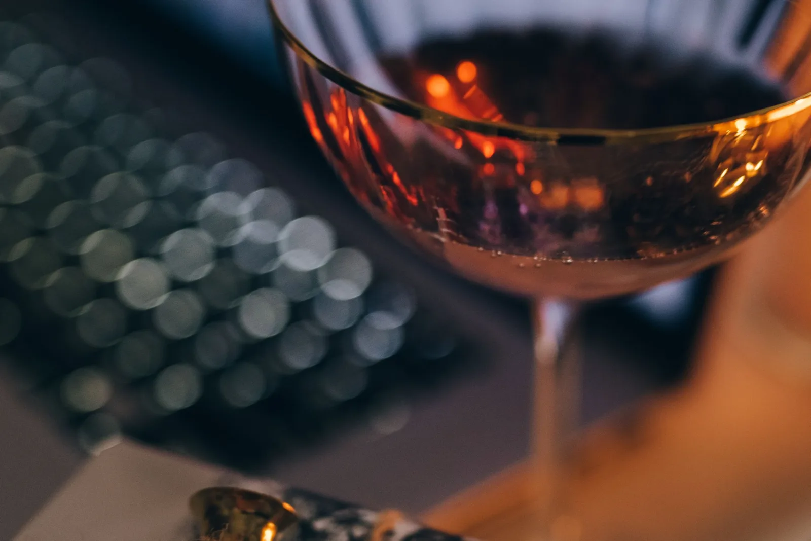 A wine glass beside a rustic box on a table