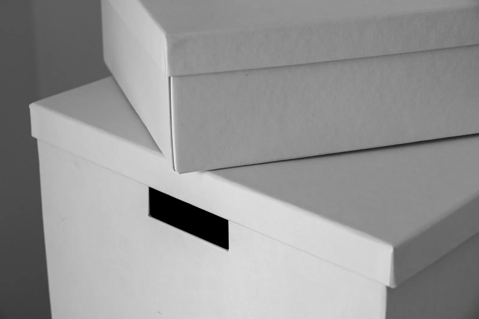 Plain white cardboard boxes stacked neatly with space around them