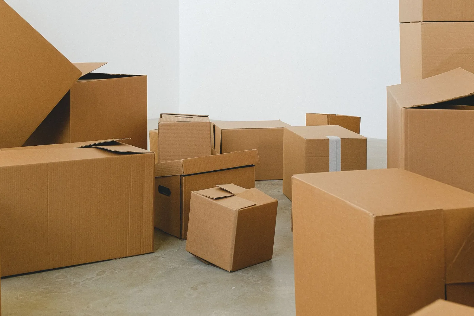 Many packed cardboard cartons covering the floor of a house being moved out of